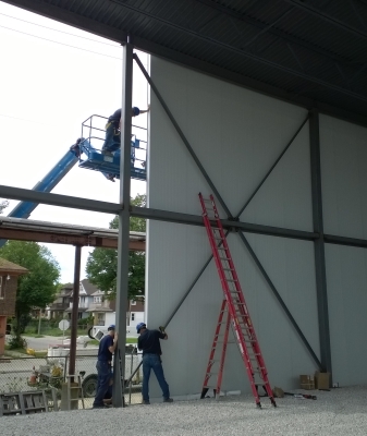 Refrigeration installers erecting insulated panels