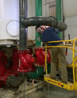 Custom refrigeration technician installing piping